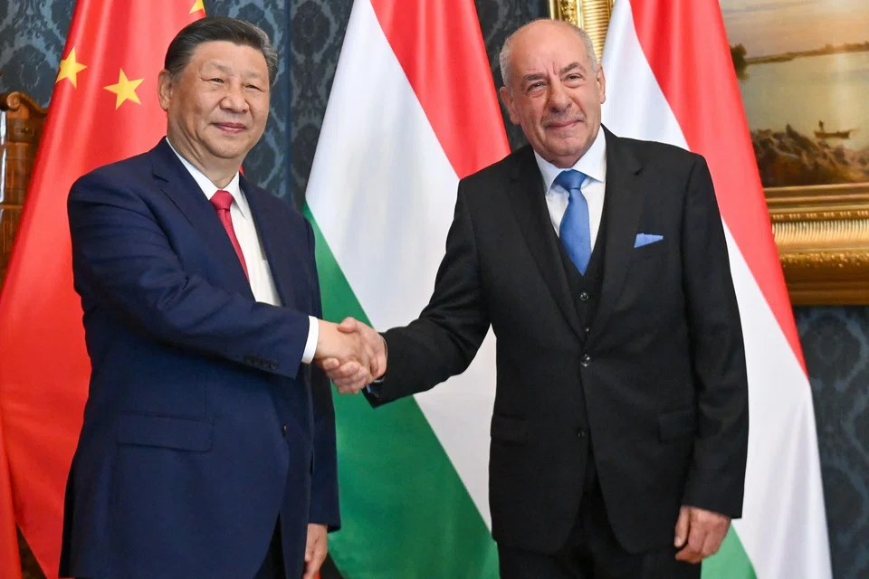 Chinese President Xi Jinping (left) shakes hands with his Hungarian counterpart Tamas Sulyok prior to their official talks in Blue Hall of presidential palace in Budapest, Hungary.