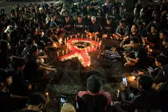 People attend a memorial remembering victims of the football match riot and stampede in Denpasar, Bali, Indonesia on Oct 2, 2022. 