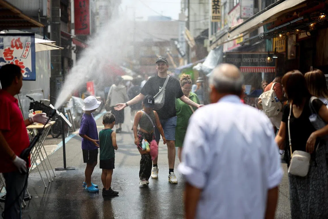 Tourists at Tsukiji Outer Market, a popular sightseeing spot, Tokyo, Japan, Aug 22, 2025.. The Japanese government issued a heatstroke alert in Tokyo and other prefectures.