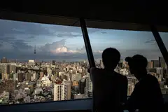 People look at the city's skyline from the Bunkyo Civic Center Observation Deck in Tokyo, Japan, Aug 14, 2024. Typhoon Ampil is set late on Thursday to skirt the Tokyo region - home to almost 40 million people - and then churn up the Pacific coast on Friday and Saturday.