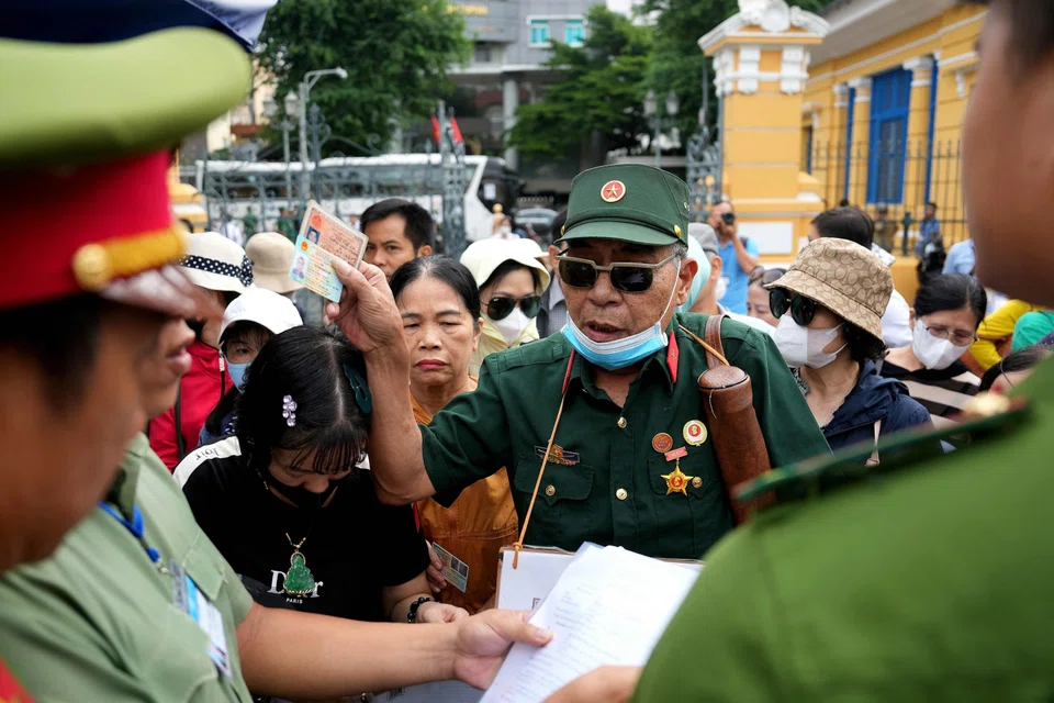 A Vietnam war veteran and fraud victim arrives with other victims to attend the court proceedings of property tycoon Truong My Lan in Ho Chi Minh City.