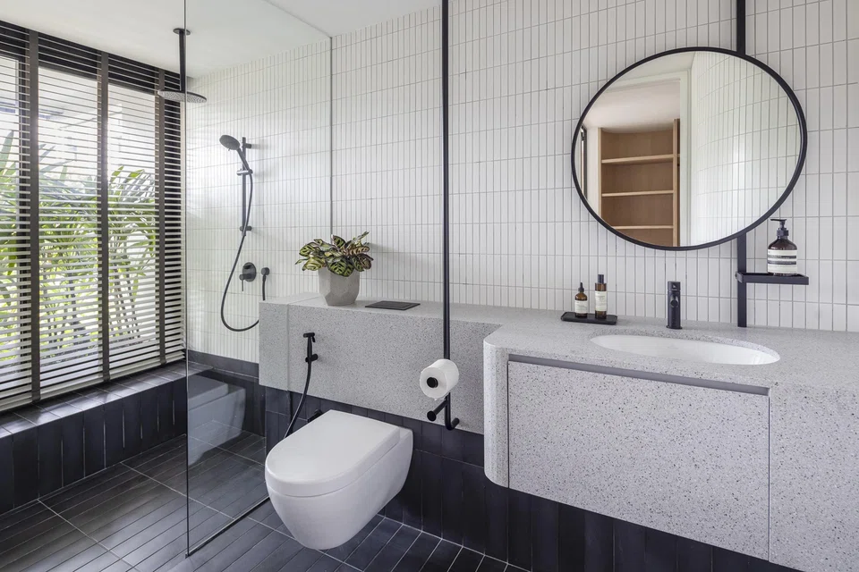 The 1970s black metal pipe railings for the stairs were the  inspiration for the bespoke bathroom accessories.