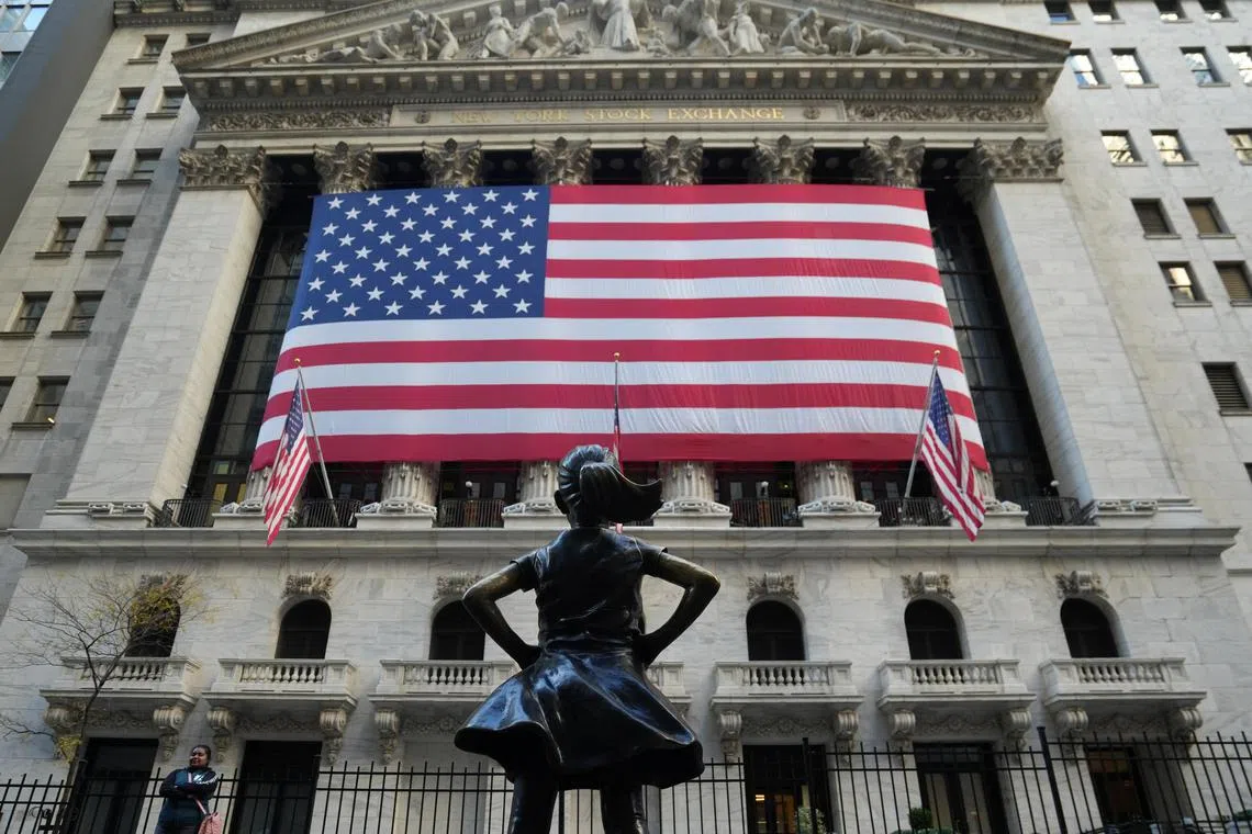 The Fearless Girl statue is pictured as an American flag hangs on the facade of the New York Stock Exchange in Manhattan on the 2024 U.S. Presidential Election Day in Manhattan in New York City, U.S., November 5, 2024. REUTERS/Stephani Spindel