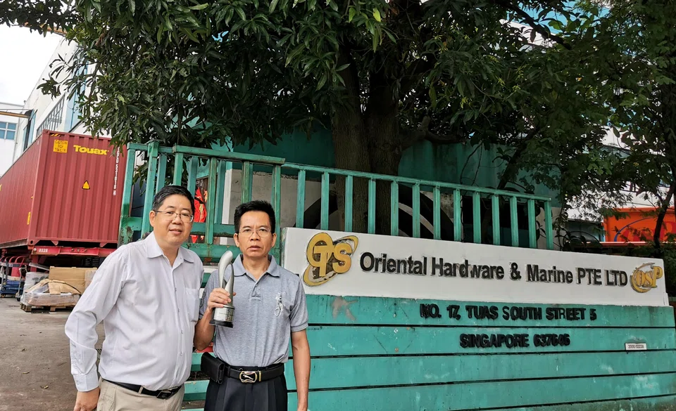 Oriental Hardware & Marine's international sales and safety manager Ken Lim (left) and managing director Lin Yong, with their Enterprise 50 award trophy from 2021.