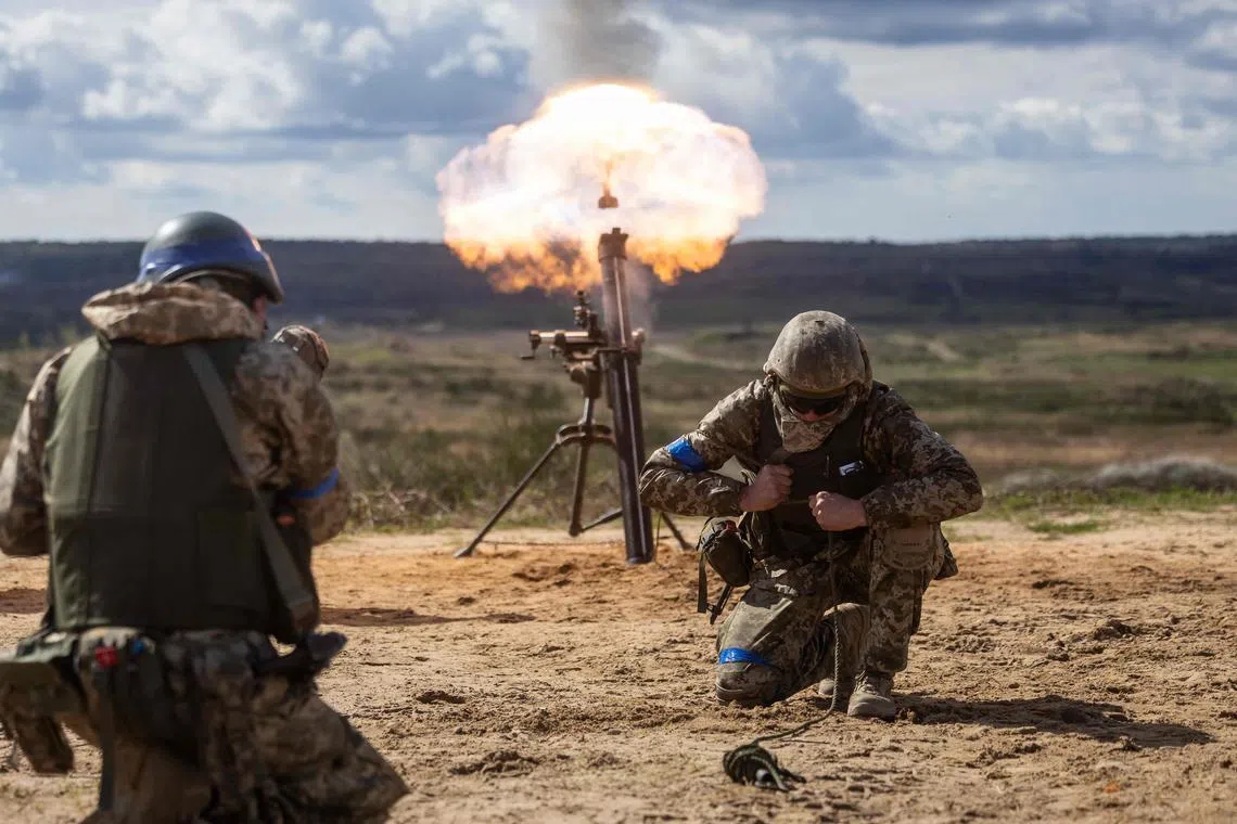 Ukrainian soldiers fire a mortar during military training with French servicemen. The UK and France have provided Ukraine with weapons, aid, training and finance.