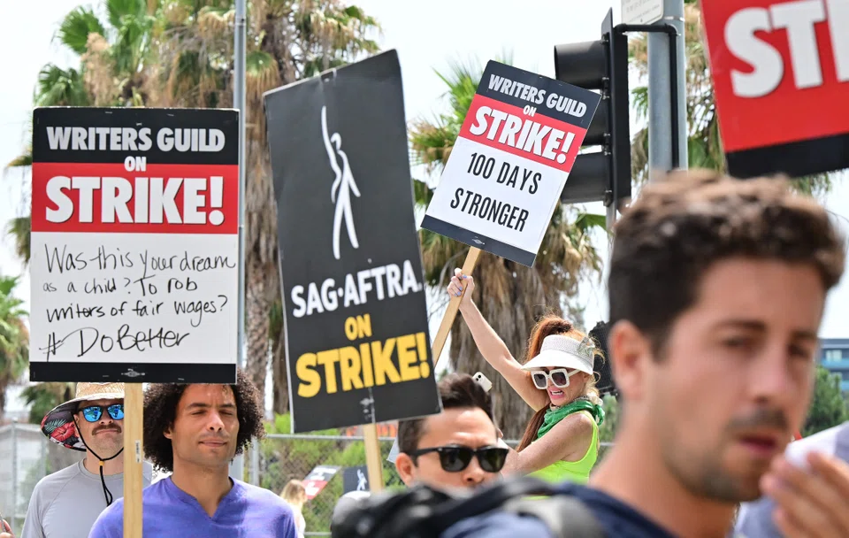 Members of the Writers Guild of America (WGA) and the Screen Actors Guild walk the picket line outside of Netflix in Hollywood, California, on Aug 9, 2023. 