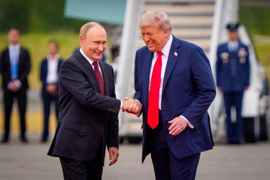 ANCHORAGE, ALASKA - AUGUST 15: (EDITOR'S NOTE: Alternate Crop) U.S. President Donald Trump (R) greets Russian President Vladimir Putin as he arrives at Joint Base Elmendorf-Richardson on August 15, 2025 in Anchorage, Alaska. The two leaders are meeting for peace talks aimed at ending the war in Ukraine.   Andrew Harnik/Getty Images/AFP (Photo by Andrew Harnik / GETTY IMAGES NORTH AMERICA / Getty Images via AFP)