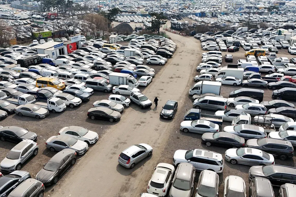 A drone view of used cars that are mostly exported to countries in the Middle East remain parked at a used-car export complex in Incheon, South Korea, on Mar 16.