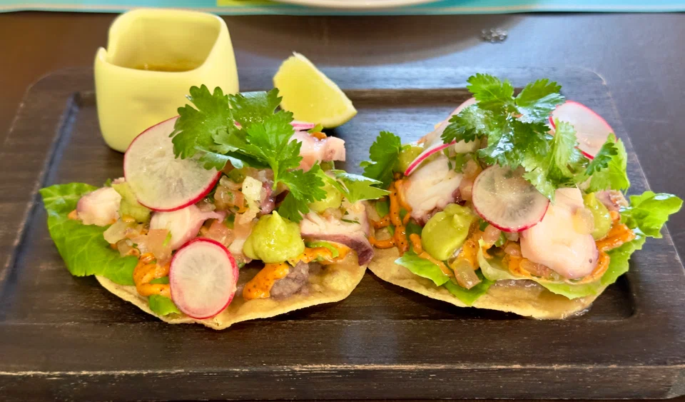 Tostadas de Pulpo feature crunchy corn tortillas topped with octopus salad.