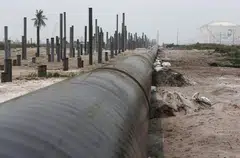 An oil pipeline is laid next to the Vopak-Dialog oil storage facility (R) and a Refinery and Petrochemical Integrated Development (RAPID) project construction site in Pangerang in Malaysia's southern state of Johor October 6, 2015. Liquefied Petroleum Gas, long a niche product used by the poor to cook and the rich to barbecue, has become a rare bright spot amid a broad commodities rout, riding on the wave of strong economic growth in India and parts of Southeast Asia.   REUTERS/Edgar Su