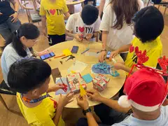 Touch Young Arrows beneficiaries making Christmas cards with volunteers at the festive celebration on Saturday at Coliwoo Boon Lay.