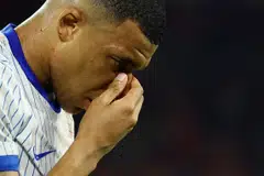 France's Kylian Mbappe holds his face after breaking his nose during the Austria vs France game in Dusseldorf, Germany, June 17, 2024.