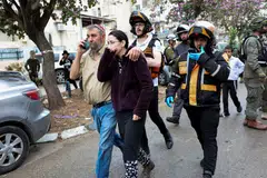 Israeli emergency personnel evacuating people from an impact site, after Iran launched missiles towards Israel, in Bnei Brak, on Apr 1.