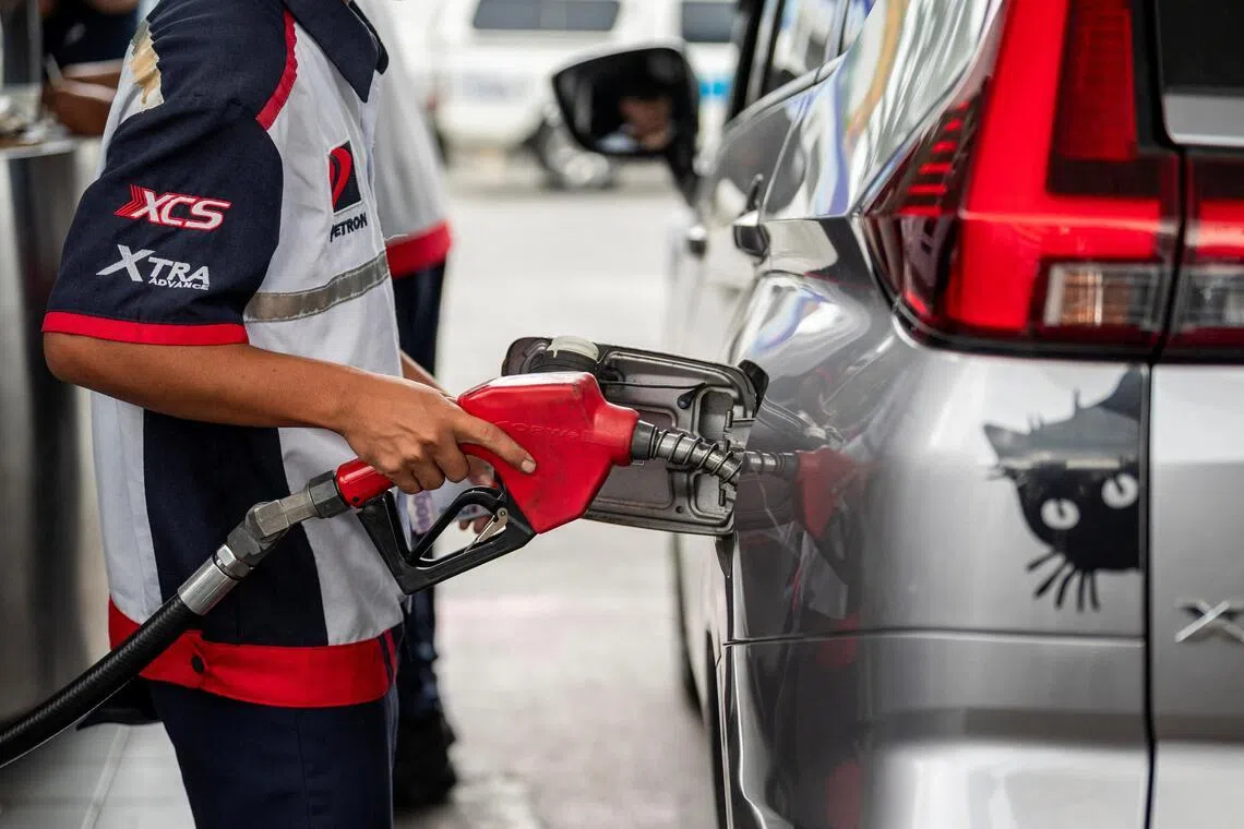 A worker fills up a car at a gas station as oil prices are expected to increase amid the U.S.-Israel conflict with Iran, in Quezon City, Metro Manila, Philippines, March 9, 2026. REUTERS/Lisa Marie David