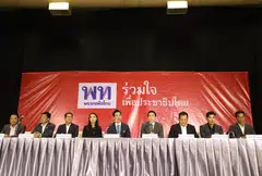 Move Forward Party leader Pita Limjaroenrat (C) speaks to the media after a meeting with the working group of seven party allies to form a coalition government on 06 June 2023. The election commission wants to disband the party for violating the constitution.