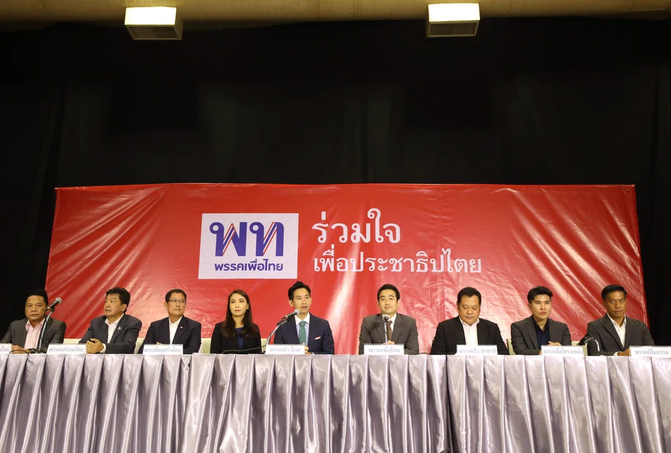 Move Forward Party leader Pita Limjaroenrat (C) speaks to the media after a meeting with the working group of seven party allies to form a coalition government on 06 June 2023. The election commission wants to disband the party for violating the constitution.