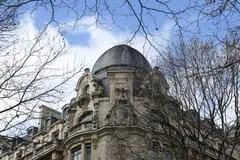 The Paris-based company is adding staff in Japan as other banks are slashing headcount globally amid slowing business activity. 