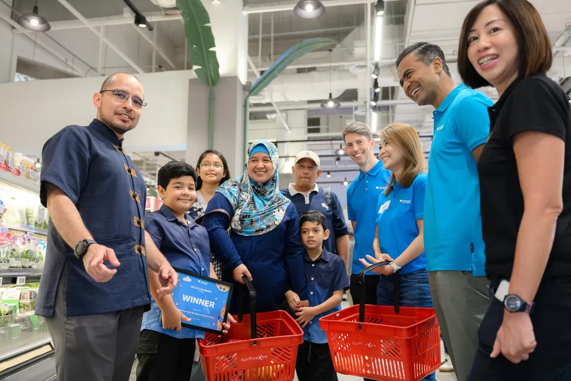 Accompanying a family during the guided shopping experience were Dr Syed Harun (first from left), Member of Parliament for Nee Soon GRC; Dwaipayan Sadhu, CEO of Trust Bank (second from right); and Denise Low (first from right), service delivery division director at MSF.