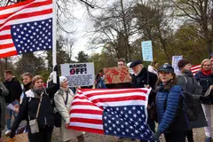 Demonstrators hold US flags upside-down during a protest against US President Donald Trump on Apr 5 in Berlin.