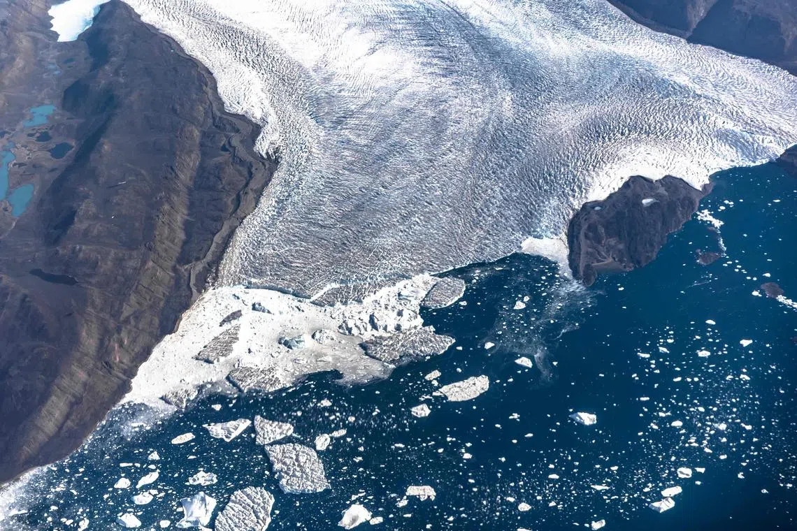 Icebergs and ice sheet in the Baffin Bay near Pituffik, Greenland on July 19, 2022. Global sea ice cover reached a historic low in February 2025, Europe's climate monitor said, with temperatures spiking up to 11 deg C above average near the North Pole as the world continued its persistent heat streak. 