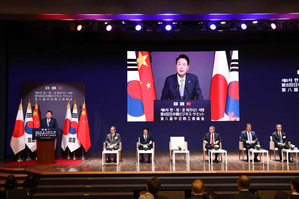 South Korean President Yoon Suk Yeol speaks as Japanese Prime Minister Fumio Kishida (3rd left) and Chinese Premier Li Qiang (right) listen during a business summit at Korea Chamber of Commerce and Industry in Seoul, South Korea, May 27, 2024. 