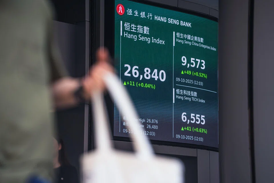A screen shows a declining Hang Seng Index, left, and other indices at the Hang Seng Bank headquarters at the Hang Seng Bank Ltd. headquarters in Hong Kong, China, on Thursday, Oct. 9, 2025. HSBC Holdings Plc plans to take Hang Seng Bank private in a deal that values the lender at $37 billion, ramping up its exposure to Hong Kong as the financial hub attempts to bounce back from years of economic turbulence. Photographer: Lam Yik/Bloomberg