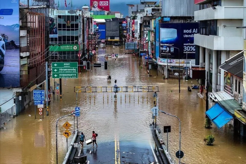A drone view shows people walking in a flooded area in Hat Yai district on Nov 23, 2025.