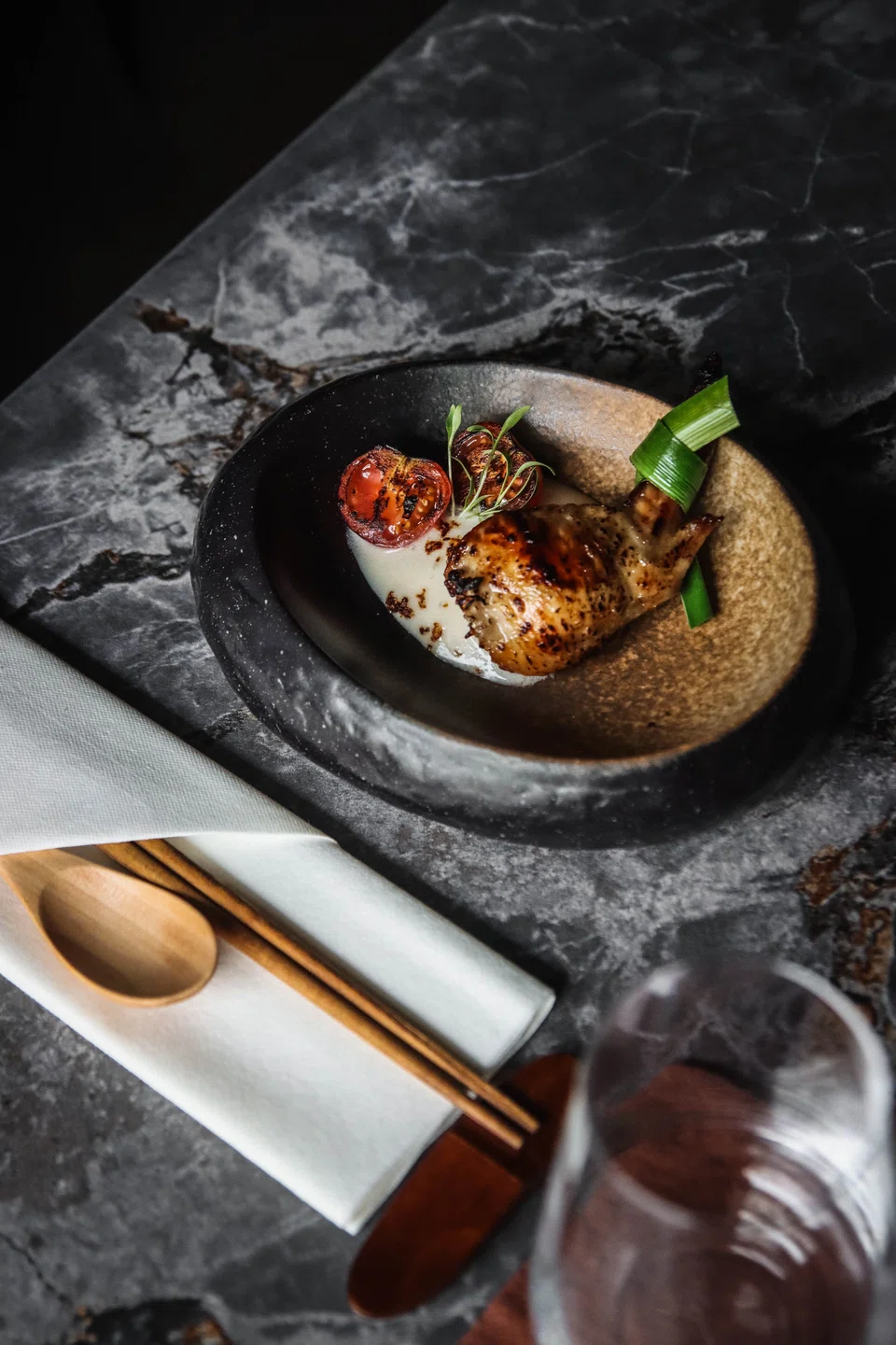 A fat, intensely seasoned chicken wing is offset with a tangy coconut espuma.