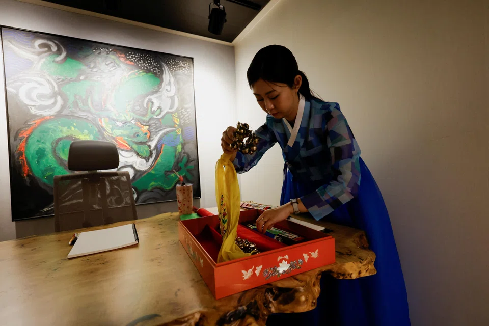 Lee Kyoung-hyun, a popular YouTuber shaman, organising tools for fortune-telling at her shaman parlour in Seoul.