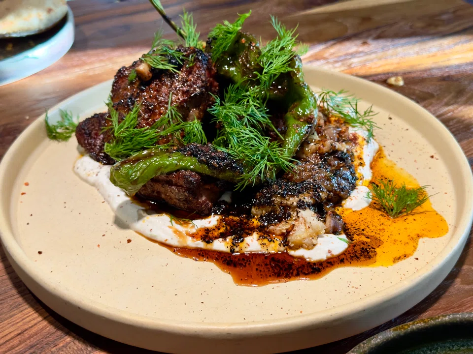 Lamb T-bone served with yoghurt and pomegranata molasses.