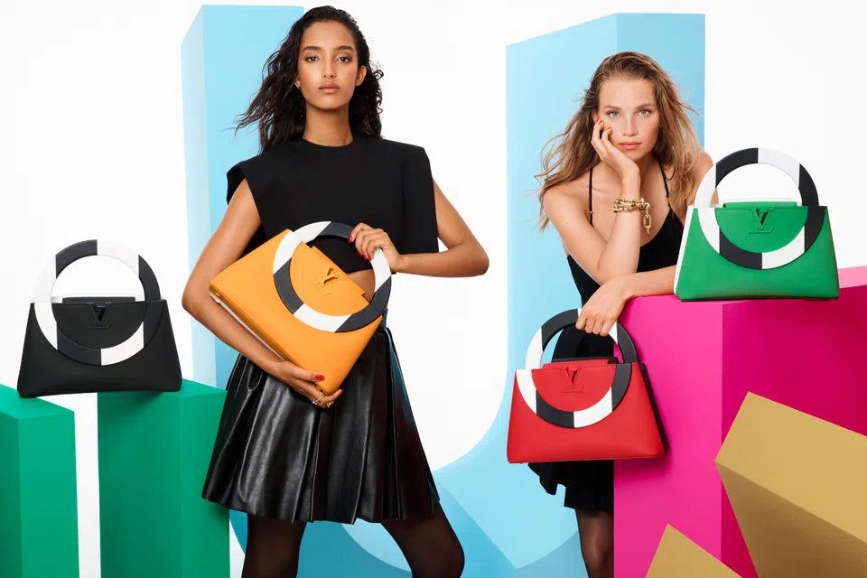 Daniel Buren reimagines the Louis Vuitton Capucines bag in four different striking colours.