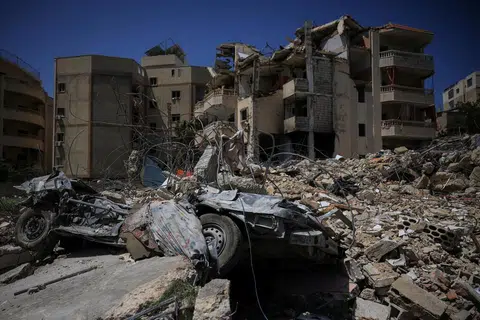 A damaged building, rubble and a destroyed vehicle in the aftermath of Israeli strikes, near Hiram Hospital in Tyre, south Lebanon, on Apr 16.