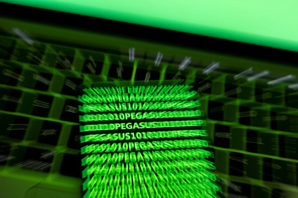 The word Pegasus and binary code are displayed on a smartphone which is placed on a keyboard in this illustration taken May 4, 2022. 