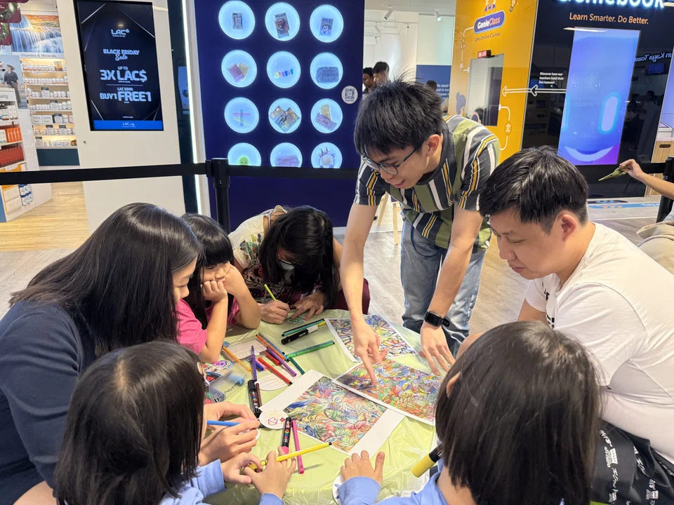 Abraham Koh (standing) conducting an art workshop at United Square.