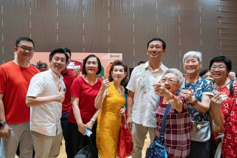 Minister Ong (4th from right), OCBC CEO Helen Wong (6th from right) and its head of global consumer financial services Sunny Quek (1st from left) with seniors at the launch of OCBC SeniorCare programme.