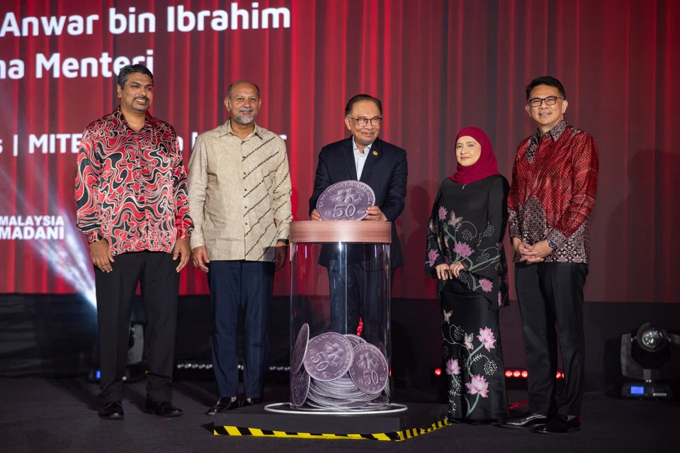 Malaysia’s Prime Minister Anwar Ibrahim (centre) at the launch of Boost Bank, the first primarily Malaysian-owned digital bank in the country.  The lender's CEO Fozia Amanulla is fourth from left.