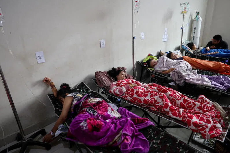 Students rest while receiving treatments for food poisoning after eating government-sponsored free school meals, at Cililin regional hospital in Bandung.