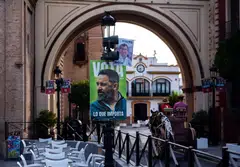 Campaign signs for the leaders of Spain's right-wing People's Party and far-right party Vox.