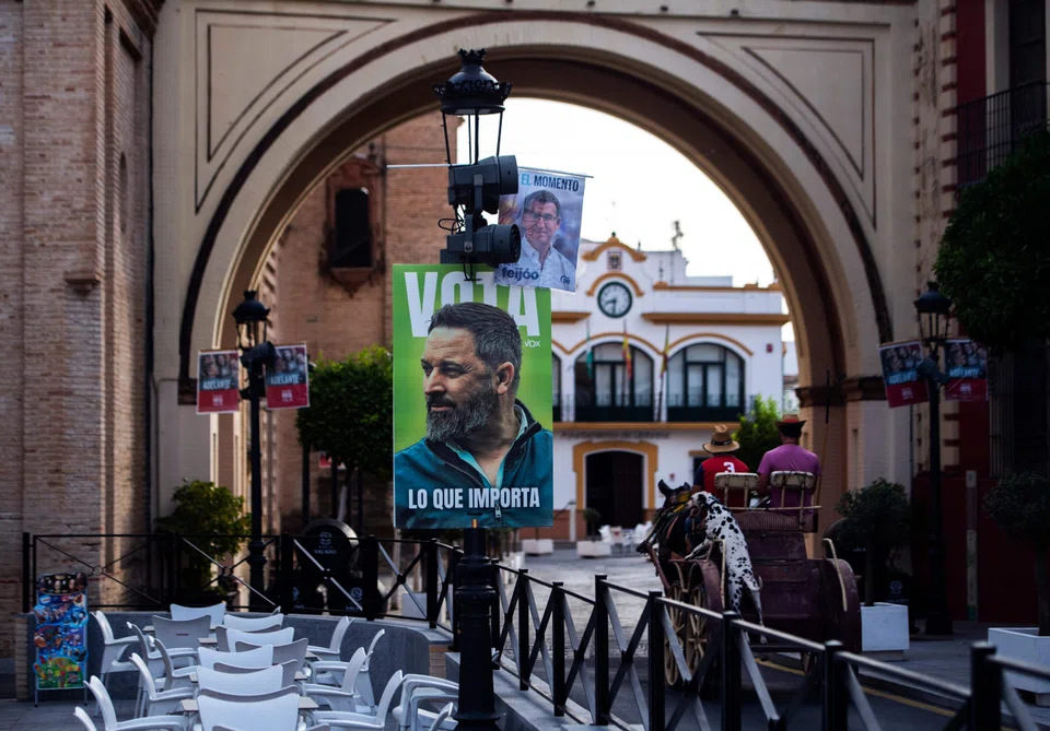 Campaign signs for the leaders of Spain's right-wing People's Party and far-right party Vox.