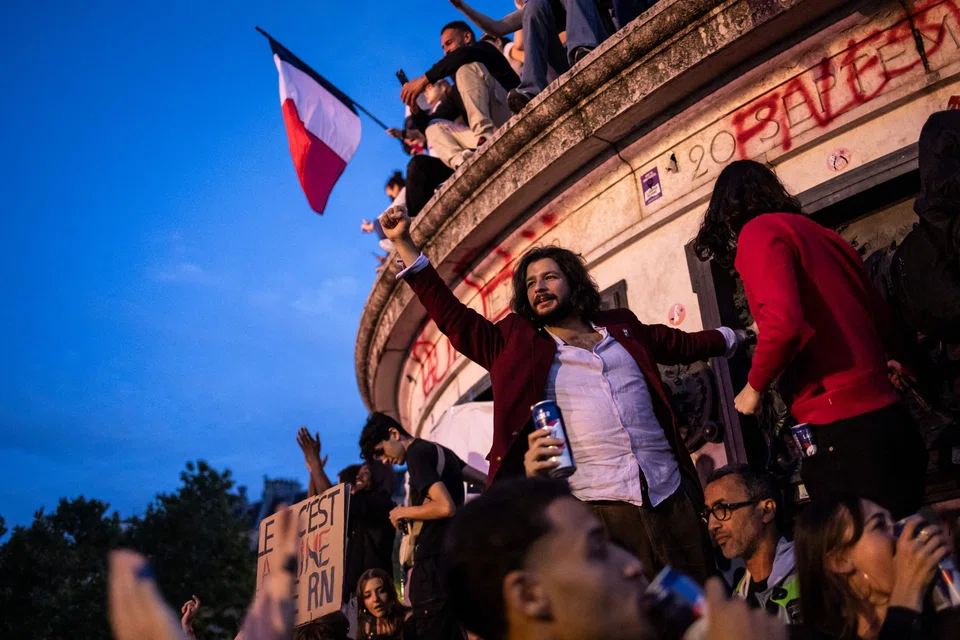 People reacting to election results at the Triumph of the Republic monument in Paris. The far-right National Rally has lost this immediate battle, but there is an even bigger war in play now for the 2027 presidential elections.