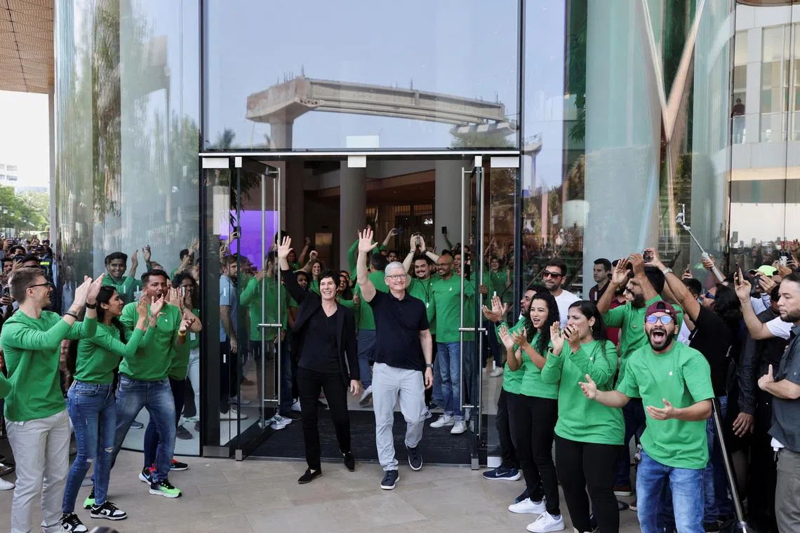 Apple CEO Tim Cook and Deirdre O'Brien, Apple's senior vice president of Retail and People greet people at the inauguration of India's first Apple retail store in Mumbai, India, April 18, 2023. REUTERS/Francis Mascarenhas     TPX IMAGES OF THE DAY     
