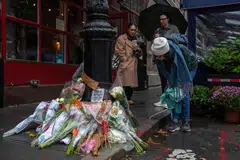 Floral tributes are left for actor Matthew Perry outside the apartment building which was used as the exterior shot in the TV show "Friends" in New York on Oct 29, 2023. 
