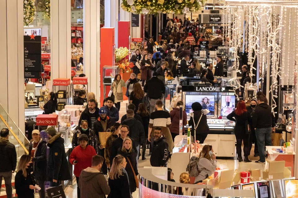 People shop at Macy's department store during Black Friday in New York City on Nov 25, 2022. 