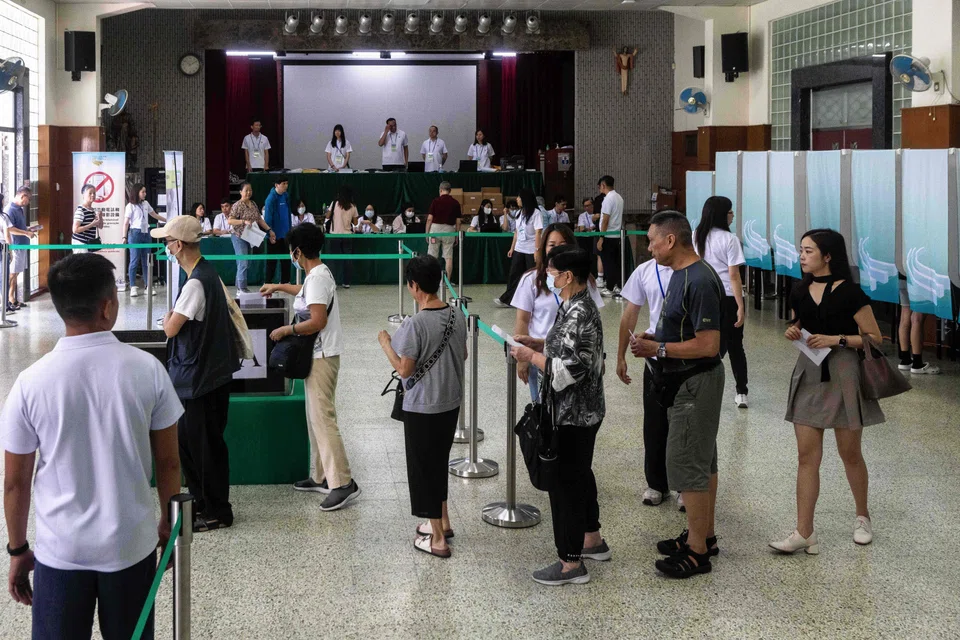 People queue to cast their ballots at a polling station in Macau, Sep 14, 2025. 