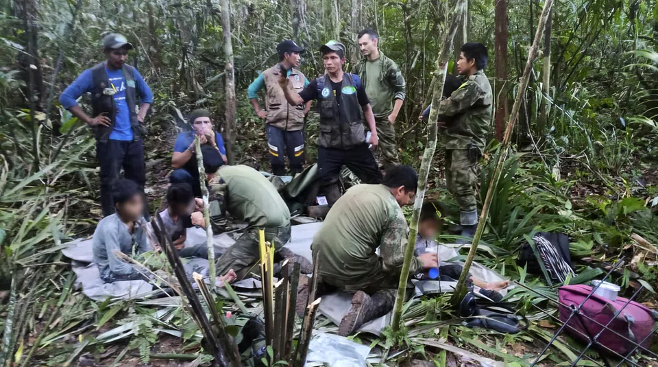 Colombian soldiers attending to the four children found alive in the Amazon jungle on June 9, 40 days after the small plane in which they were travelling crashed, killing the three adults, including their mother. 