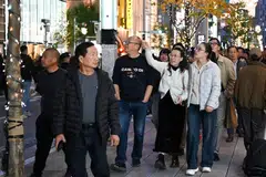 Chinese tourists walk in the Ginza shopping district in Tokyo, Japan, Nov 15, 2025. China has advised its citizens to avoid travelling to Japan, following a diplomatic row between the two countries.