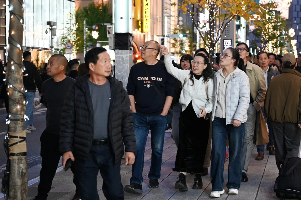 Chinese tourists walk in the Ginza shopping district in Tokyo, Japan, Nov 15, 2025. China has advised its citizens to avoid travelling to Japan, following a diplomatic row between the two countries.