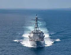 A United States Navy ship on a transit through the Taiwan Strait. In a hypothetical Taiwan Strait crisis, it is possible that out of the Quadrilateral Security Dialogue – Australia, India, Japan, and the United States – the US would be left to act alone.