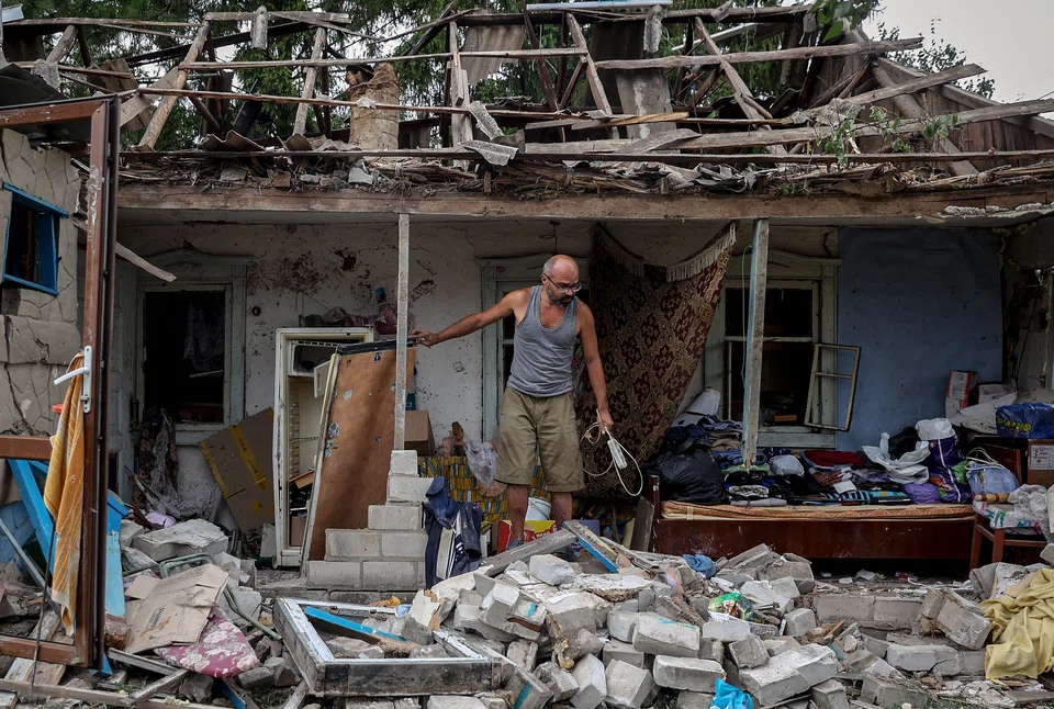 A local resident collects belongings from his destroyed house after a night missile strike in the town of Kramatorsk, in Donetsk region, on August 16, 2022, amid the Russian military invasion of Ukraine. 