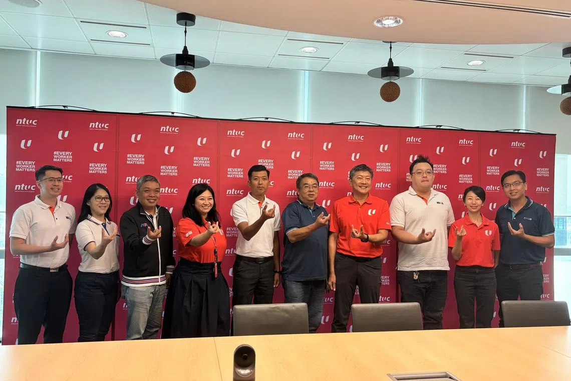 NTUC secretary-general Ng Chee Meng (seventh from left), assistant secretary-general Yeo Wan Ling (fourth from left) and director of the Union of Freelancers and Self-Employed Persons Jean See (second from right) with platform work association representatives.